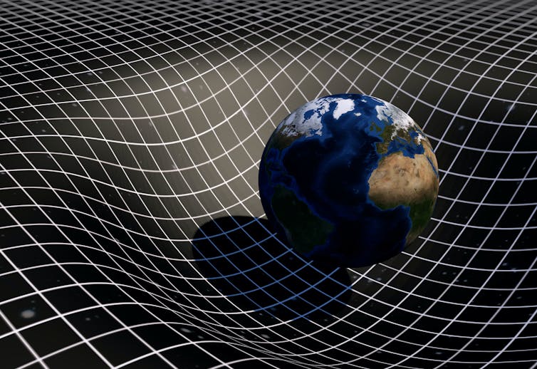 A model of the Earth showing it bend a grid representing spacetime.