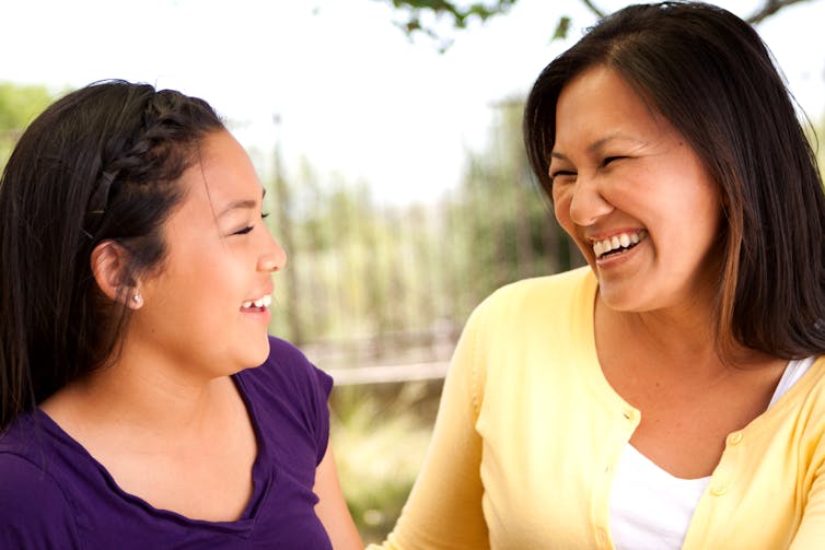 Daughter and mother smiling at each other