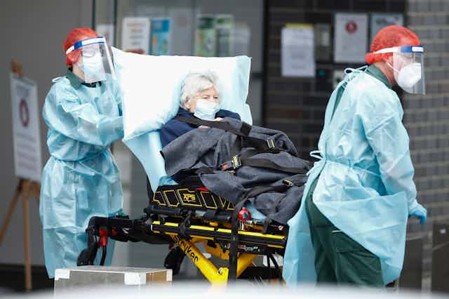 A woman infected with COVID-19 is transferred from an aged care home to hospital.