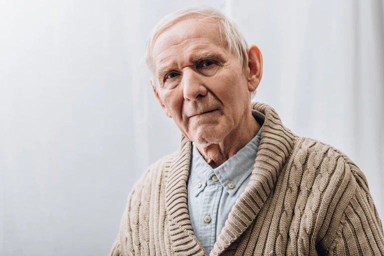Elderly man looking serious