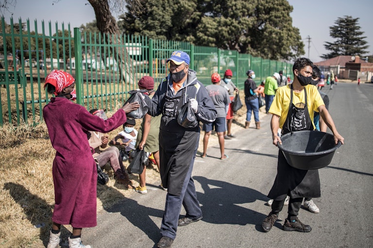 Volunteers distribute food parcels