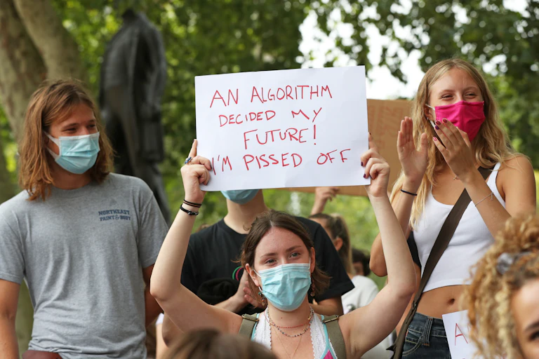Young woman in protest group holds up sign.