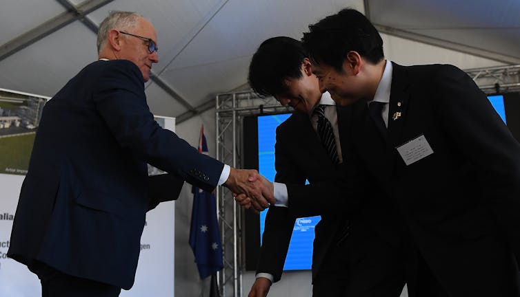 Then prime minister Malcolm Turnbull shakes hands with a Japanese dignitary at Loy Yang A power station in Victoria.