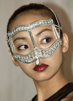 Japanese woman wears diamond eye mask.