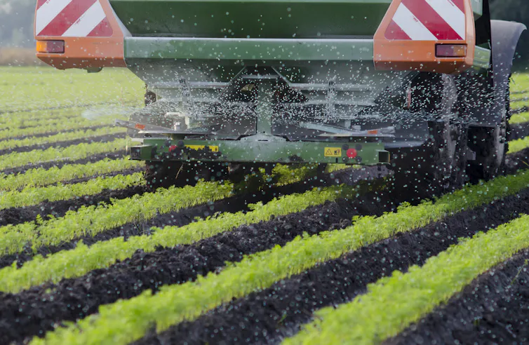 Farm machinery spreading fertiliser