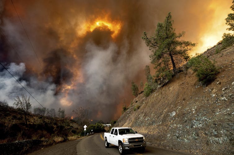 Truck driving away from wildfire