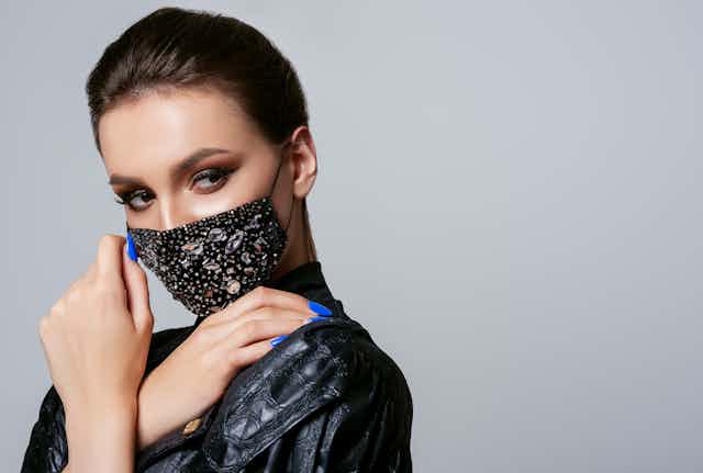 Glamorous woman wears bejewelled face mask