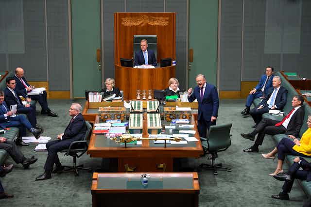 Labor leader Anthony Albanese speaking in parliament. Scott Morrison has his back turned while frontbenchers watch on.
