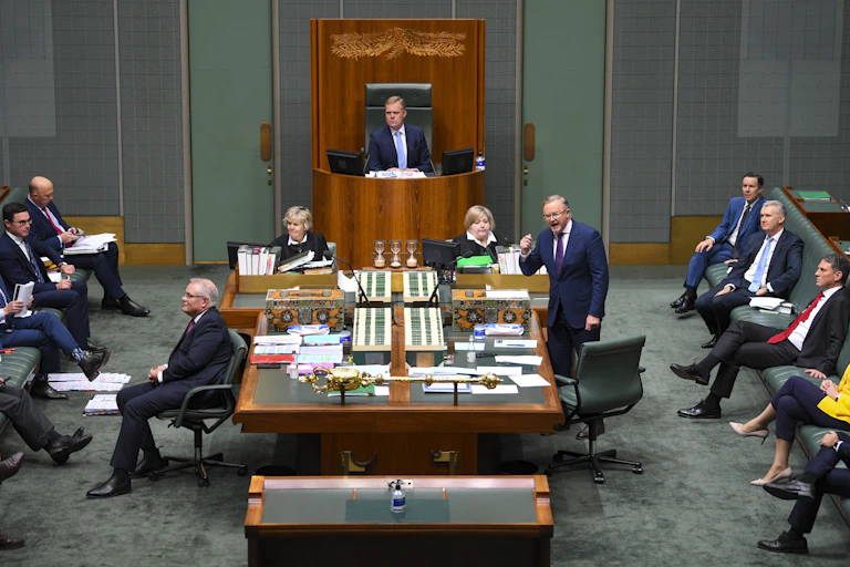Labor leader Anthony Albanese speaking in parliament. Scott Morrison has his back turned while frontbenchers watch on.