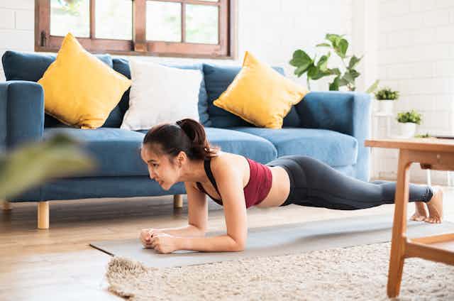 Woman planking at home