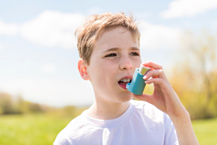 Child using inhaler.