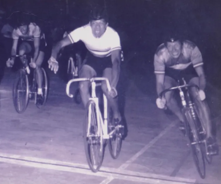 Black and white image of cyclists at the velodrome finish line