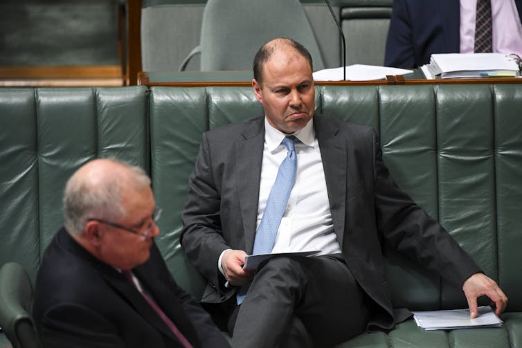 Treasurer Josh Frydenberg pulling a sad face on the frontbencher, with Prime Minister Scott Morrison in foreground.