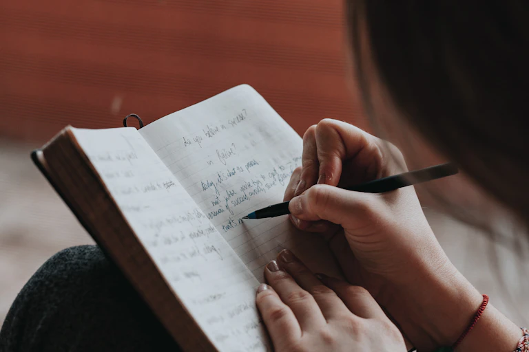 Woman writes in notebook