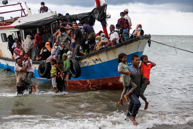 Rohingya refugees evacuated from a boat as they arrive at Lancok beach, North Aceh, Indonesia