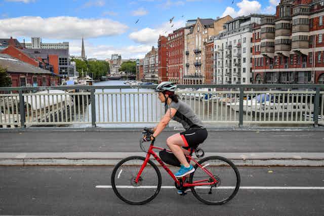 A cyclist crosses a bridge in Bristol.