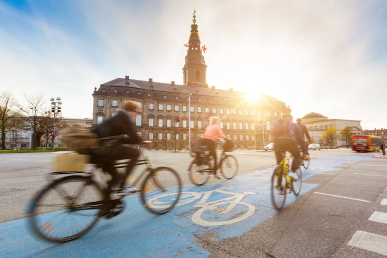 Three people commute by bike on a morning in Copenhagen.