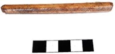 Brown flute-like tube with etchings on it.