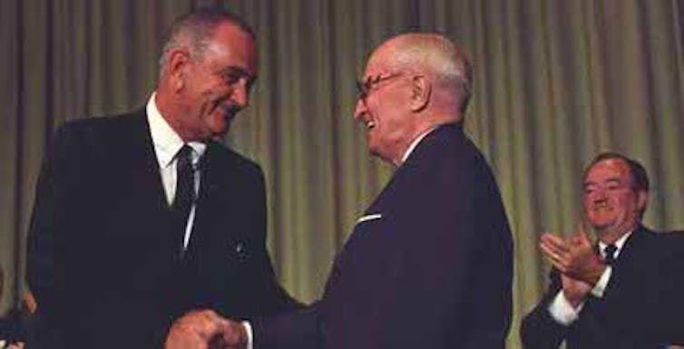 President Johnson shaking hands with former President Harry Truman.