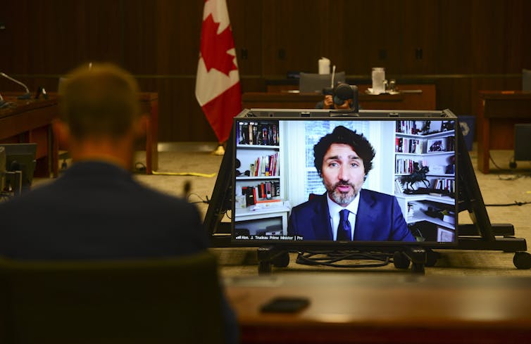 Justin Trudeau seen on a screen in a meeting room