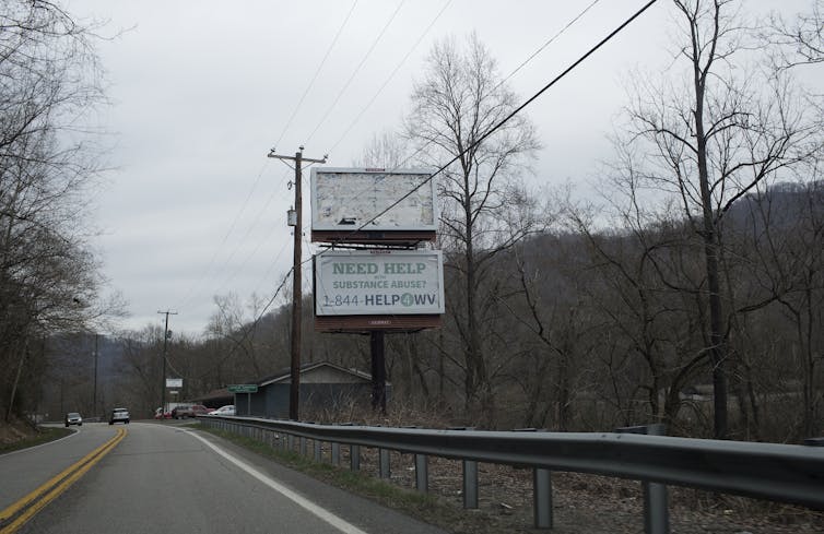 A road sign advertises help for addiction in West Virginia, one of the states hit hardest by the opioid crisis.