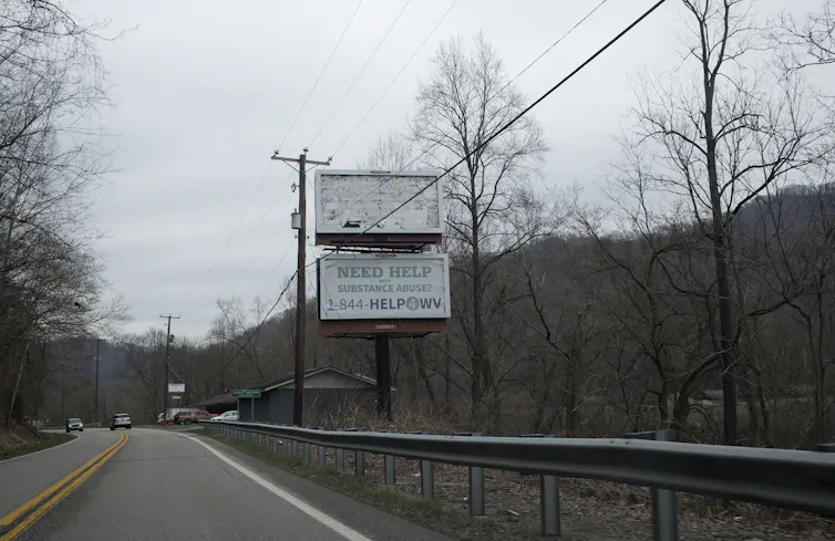 A road sign advertises help for addiction in West Virginia, one of the states hit hardest by the opioid crisis.