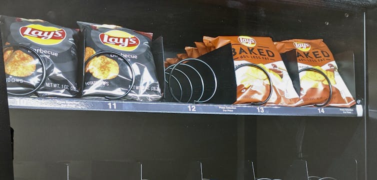 A vending machine displays Lay's BBQ potato chips and Lay's baked potato chips.
