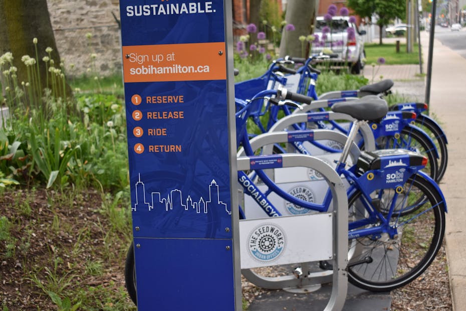 Bikes in a bike share are seen on a rack.