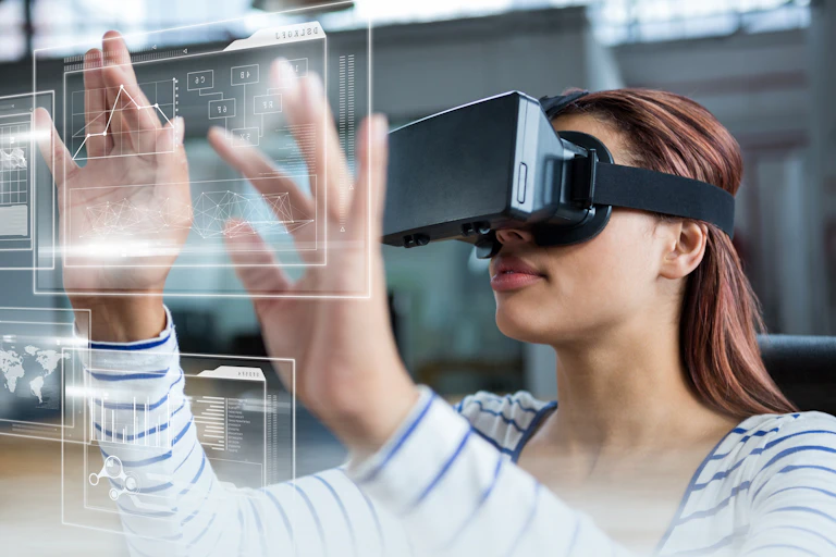 A student in a VR headset touches a screen.