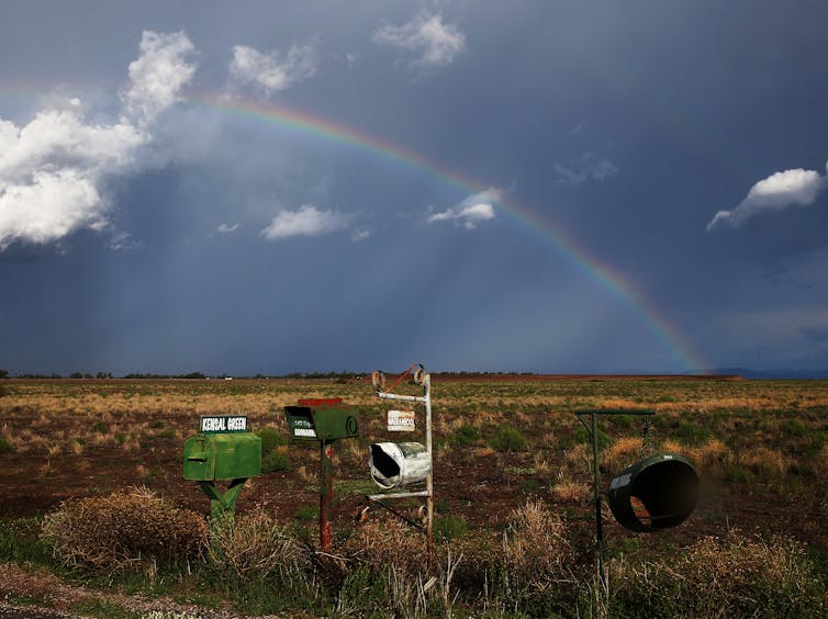 Rainbow over letterboxes in a rural setting