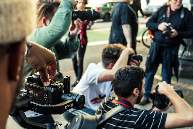 Photographers at an outdoor media conference