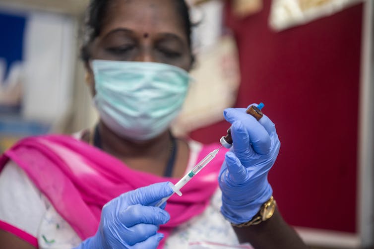 Mumbai medical worker prepares a vaccine