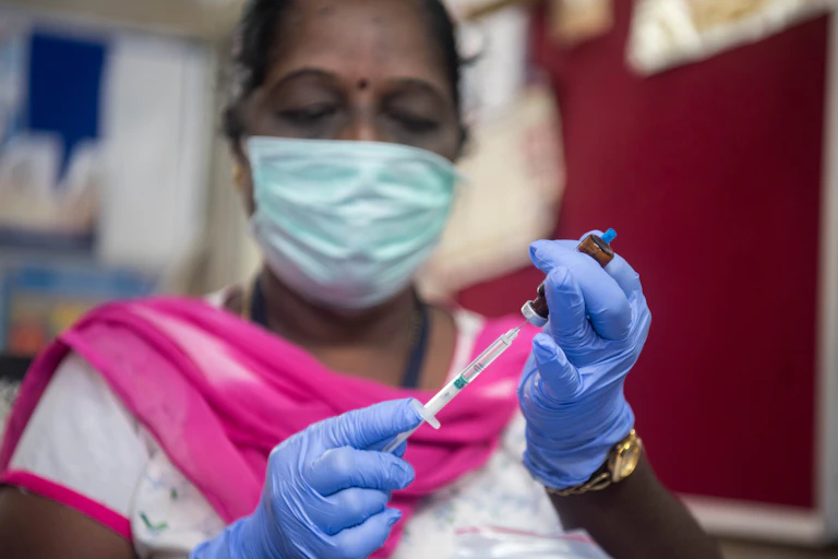 Mumbai medical worker prepares a vaccine
