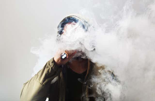 Man in a cloud of vape smoke