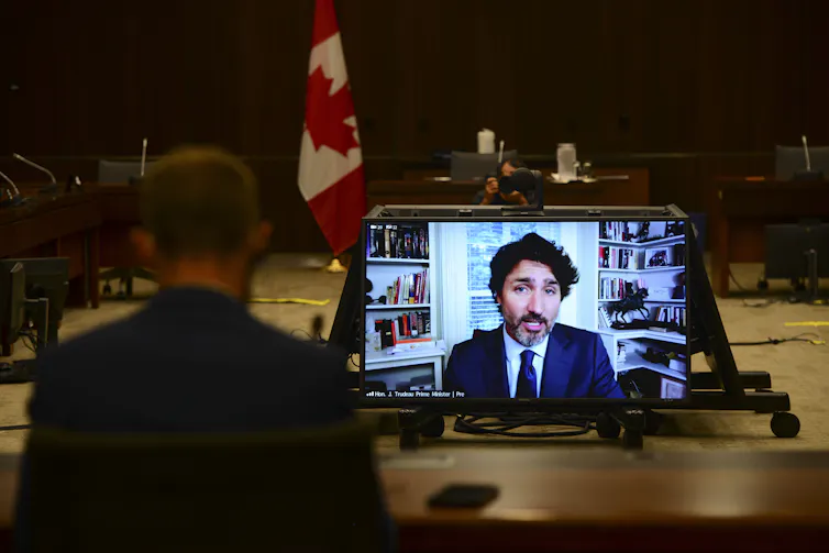 Justin Trudeau appears on screen as he testifies.