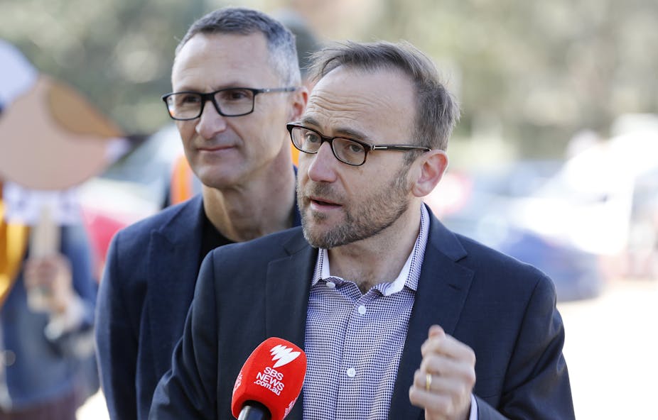 Adam Bandt speaking at a press conference with Richard Di Natale standing behind