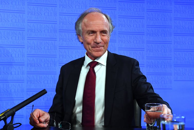 Alan Finkel smiles from a podium with the National Press Club logo in the background.