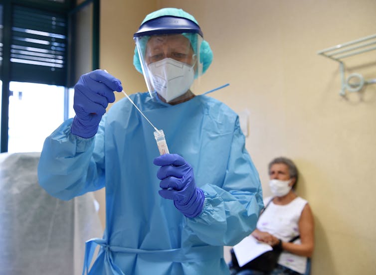 A patient has a coronavirus swab test from a medical staff