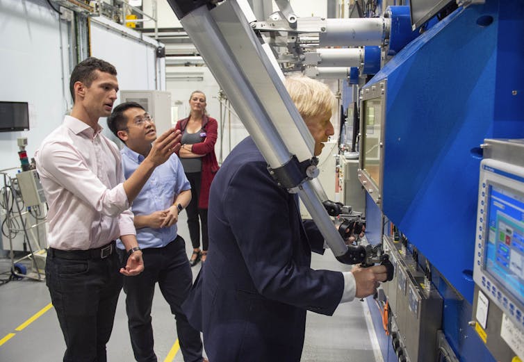 Boris Johnson looks into large industrial machine