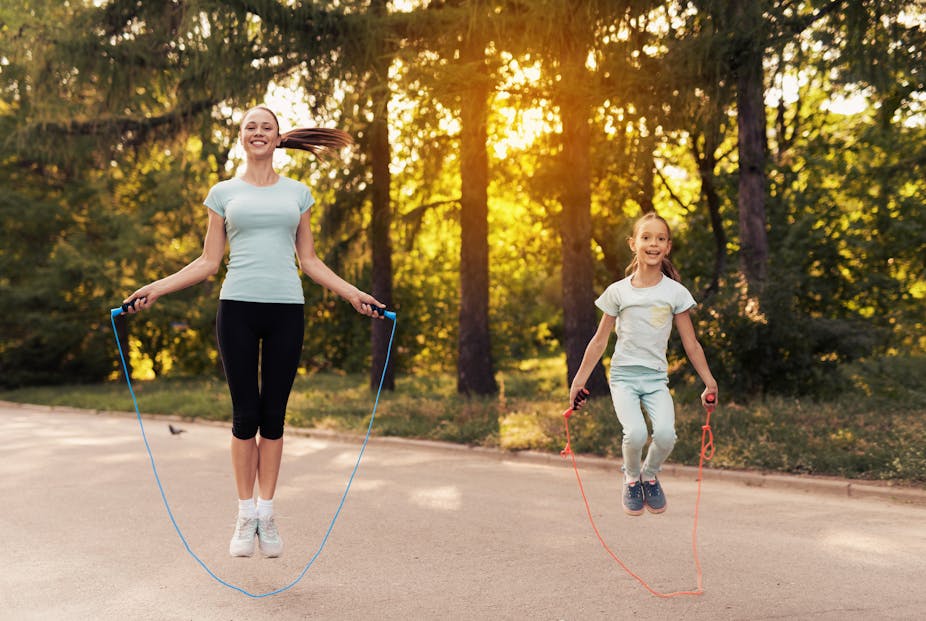 Mom and daughter jumping rope.