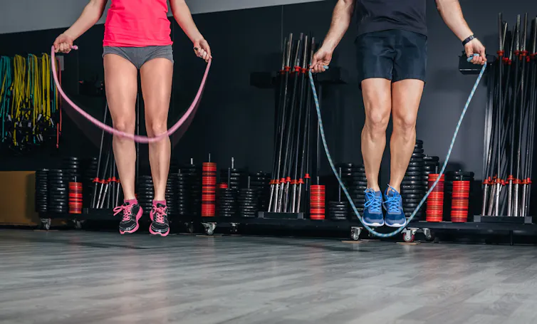 Man and a woman jump rope.