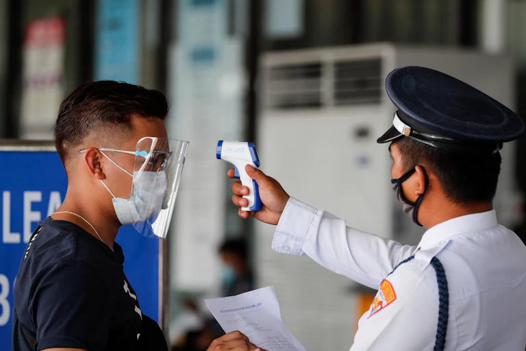 Man having his temperature checked at an airport