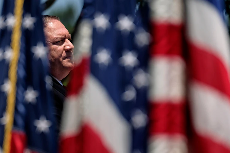 Mike Pompeo surrounded by US flags