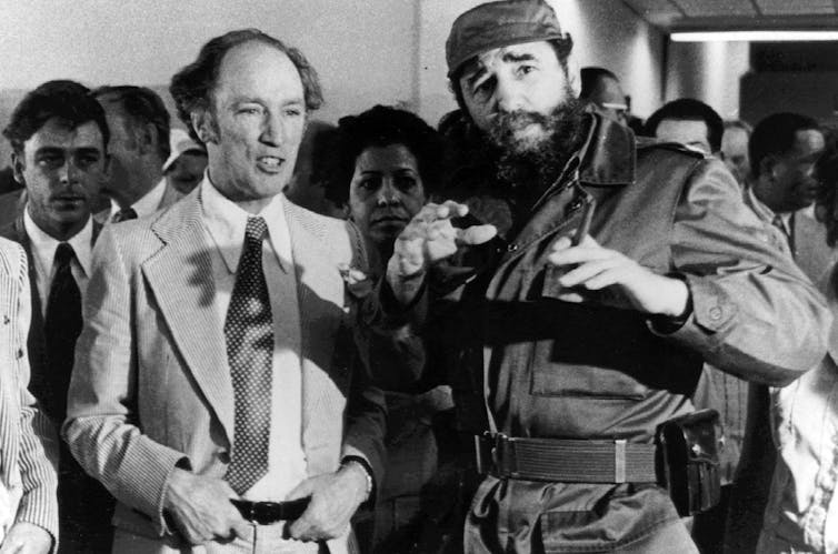 Pierre Trudeau smiles as he stands next to Fidel Castro.