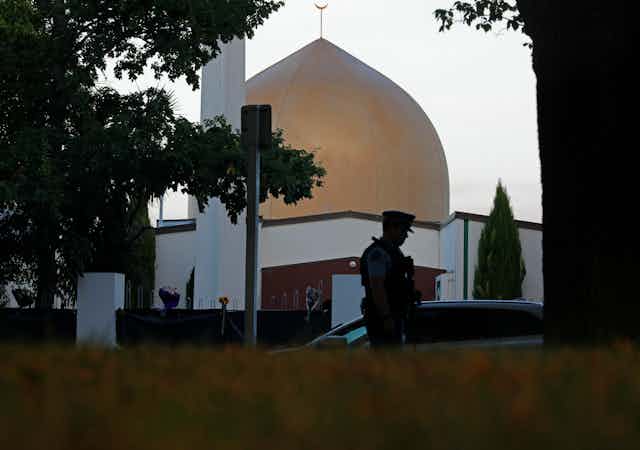 Golden dome of mosque with silhouette of policeman