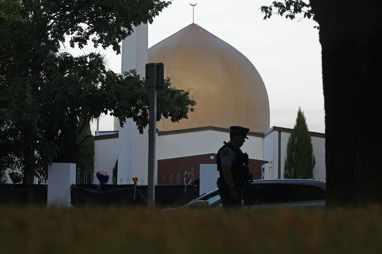Golden dome of mosque with silhouette of policeman