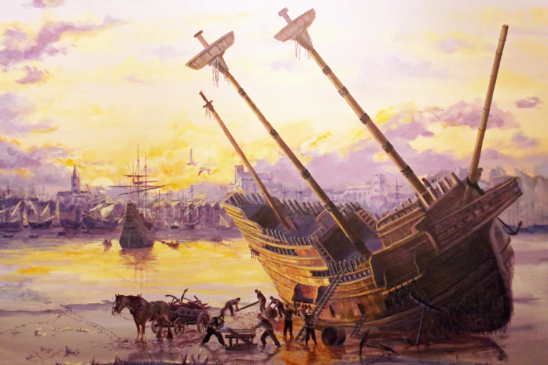 Painting of a sailing ship aground unloaded by a horse and cart.