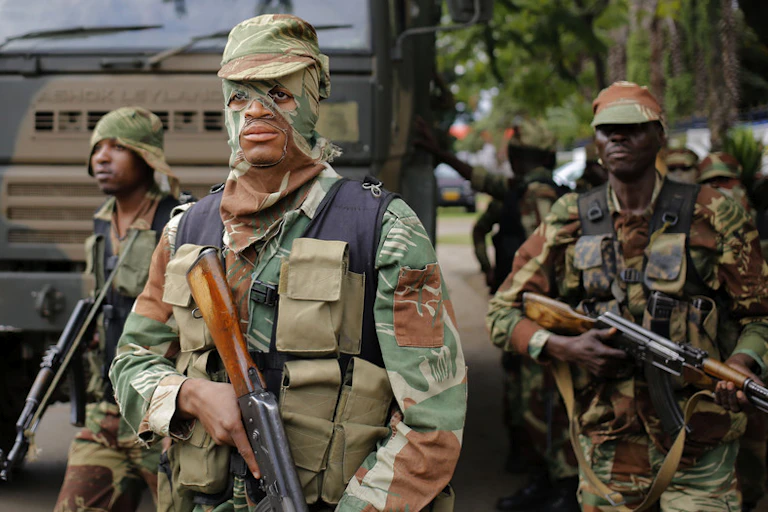 Masked soldier holding rifle.