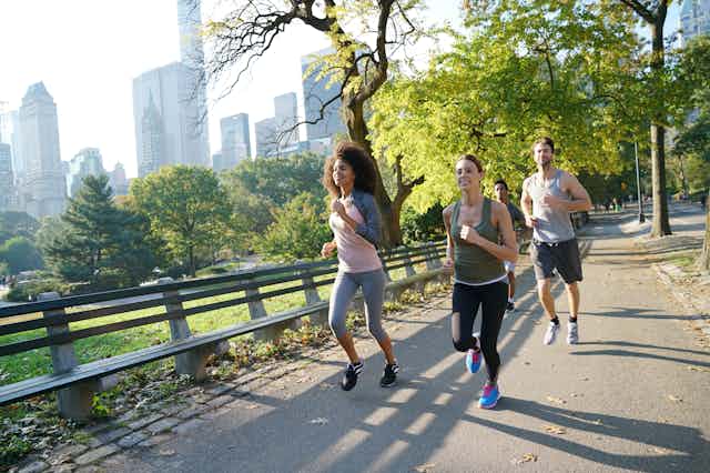 Three joggers in a park