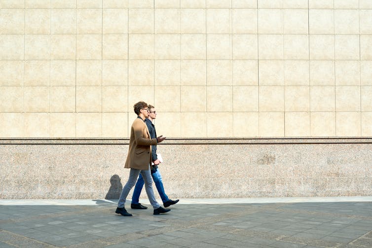 Two men walking together.